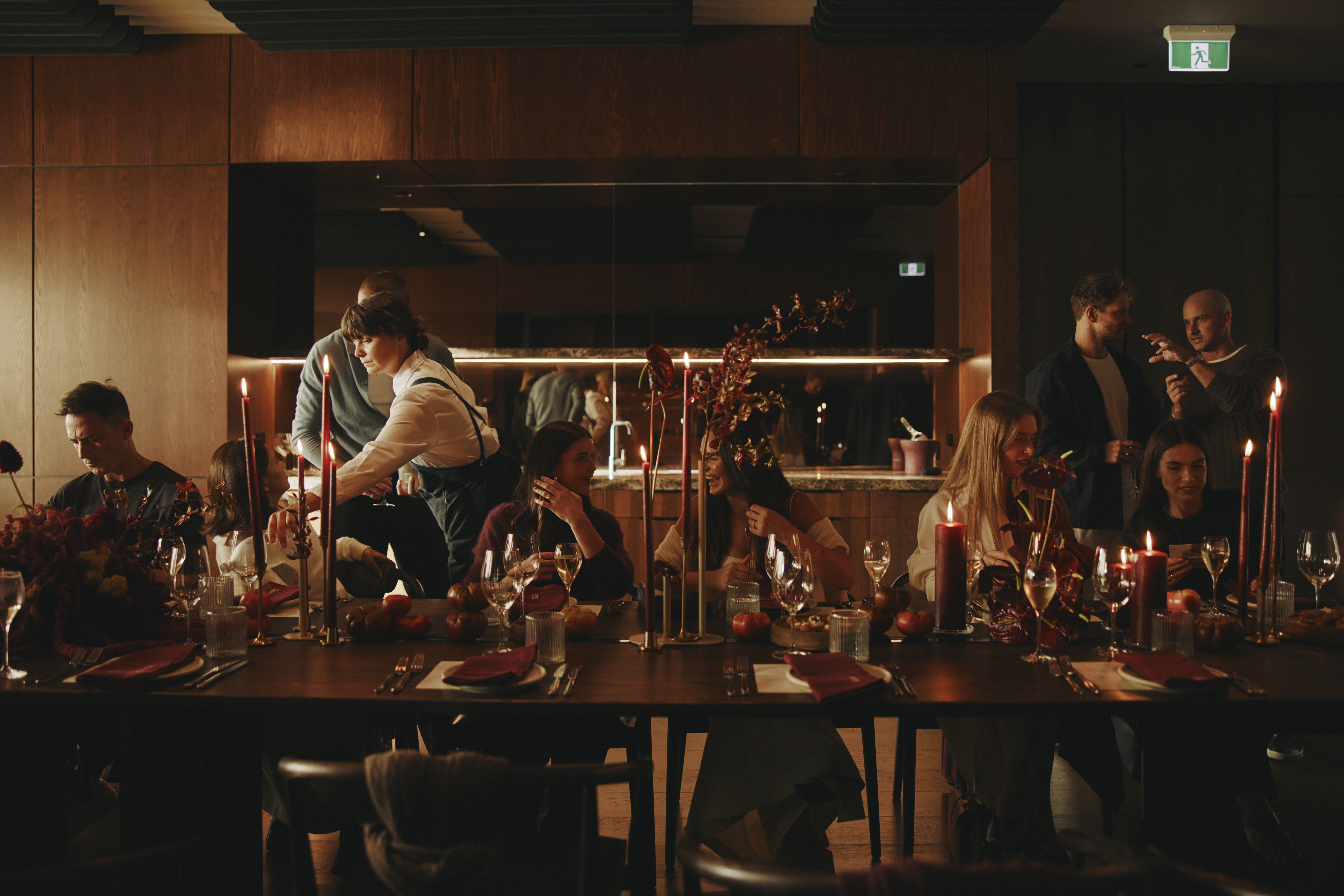 a group of people sitting at a table with wine glasses