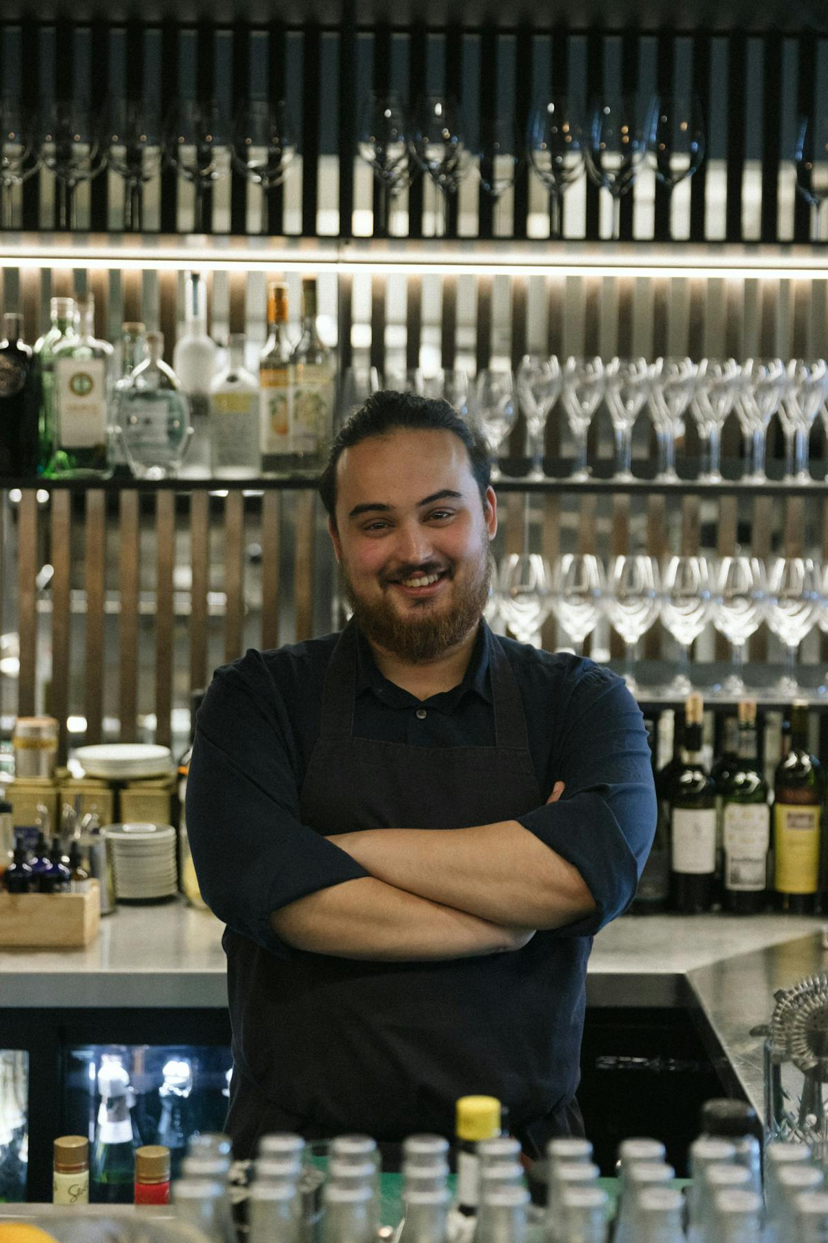 a man sitting at a table with wine glasses