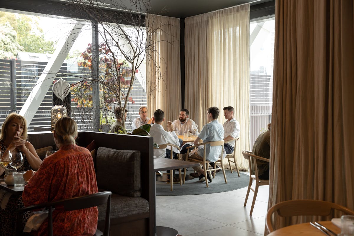 a group of people sitting in a chair in front of a window