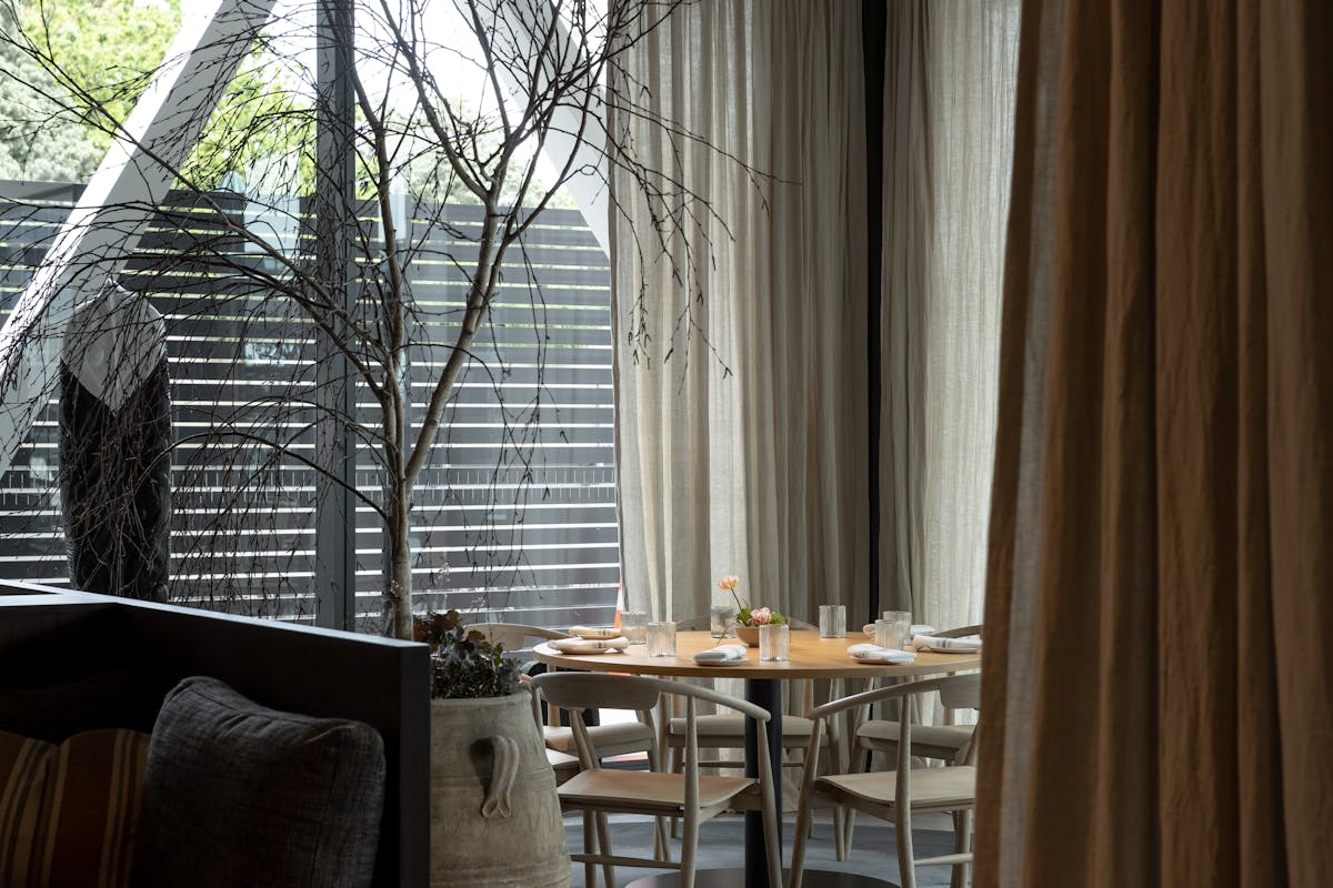 a dining room table in front of a window