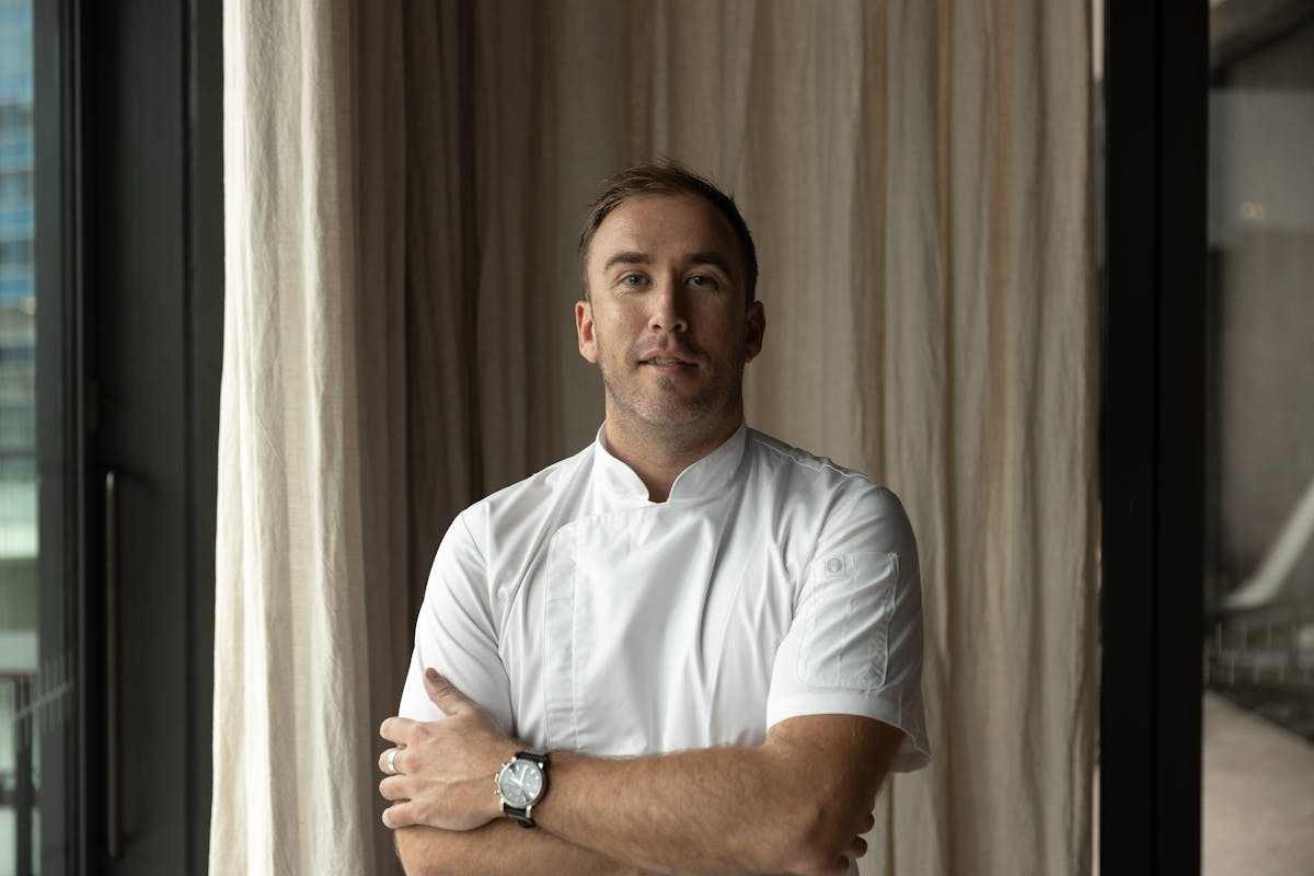 a man standing in front of a curtain