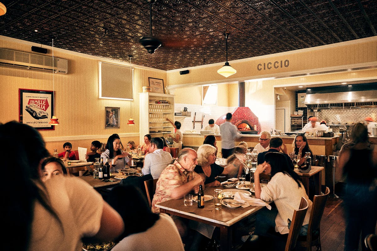 a group of people sitting at a table in a restaurant