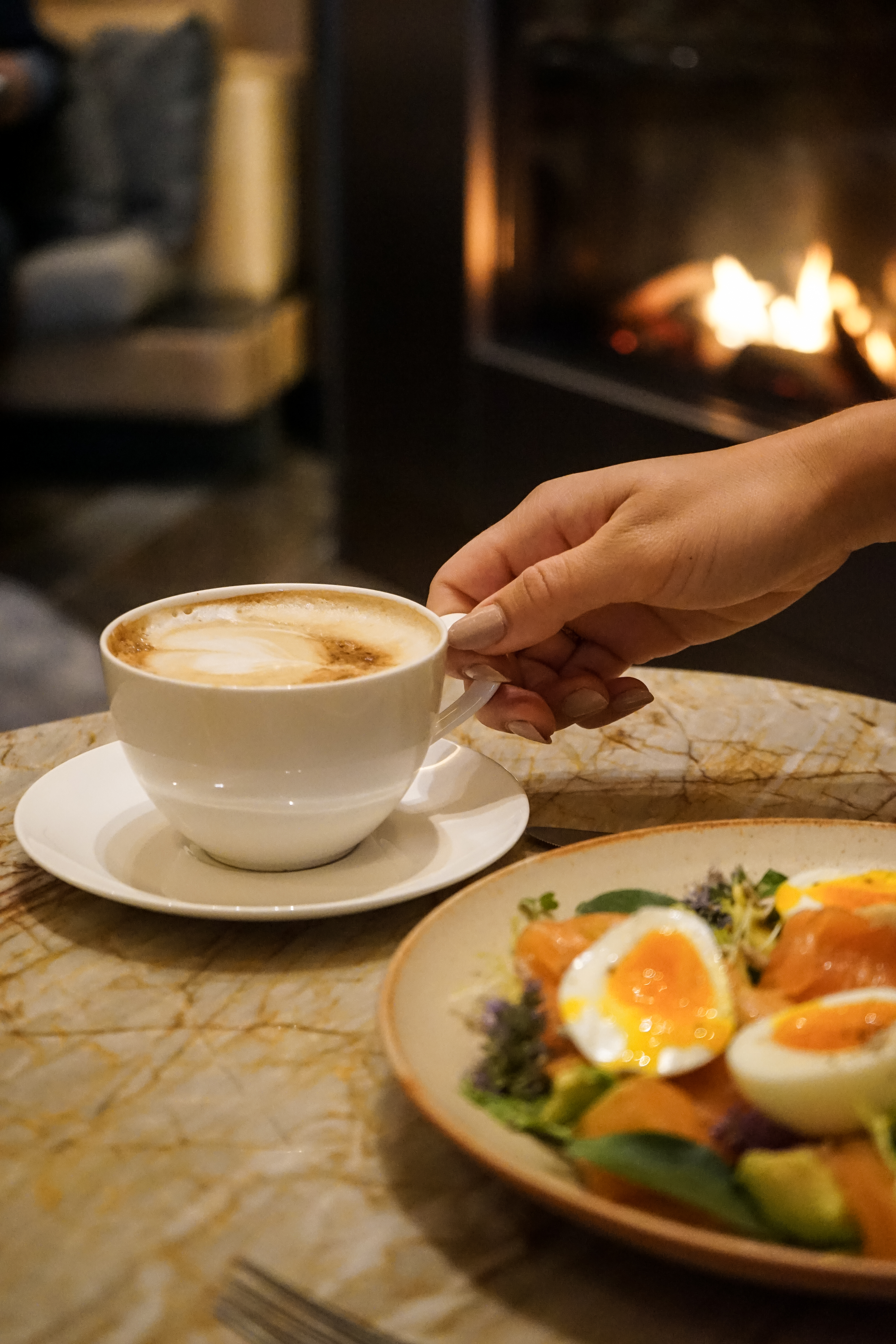 a plate of food and a cup of coffee on a table