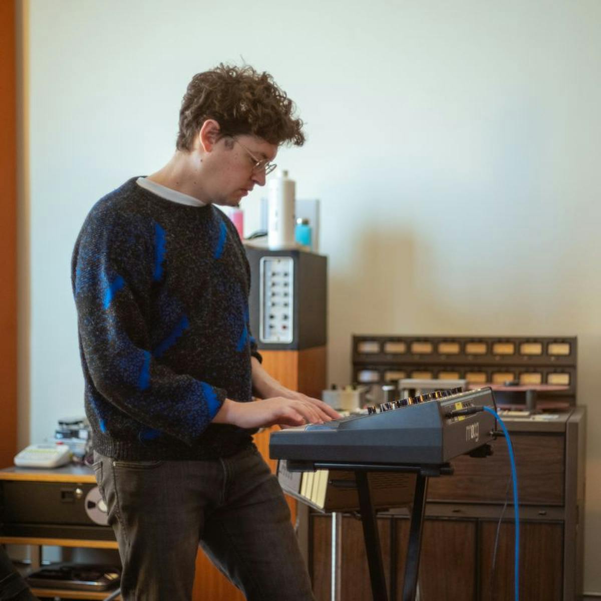 a man standing in front of a piano