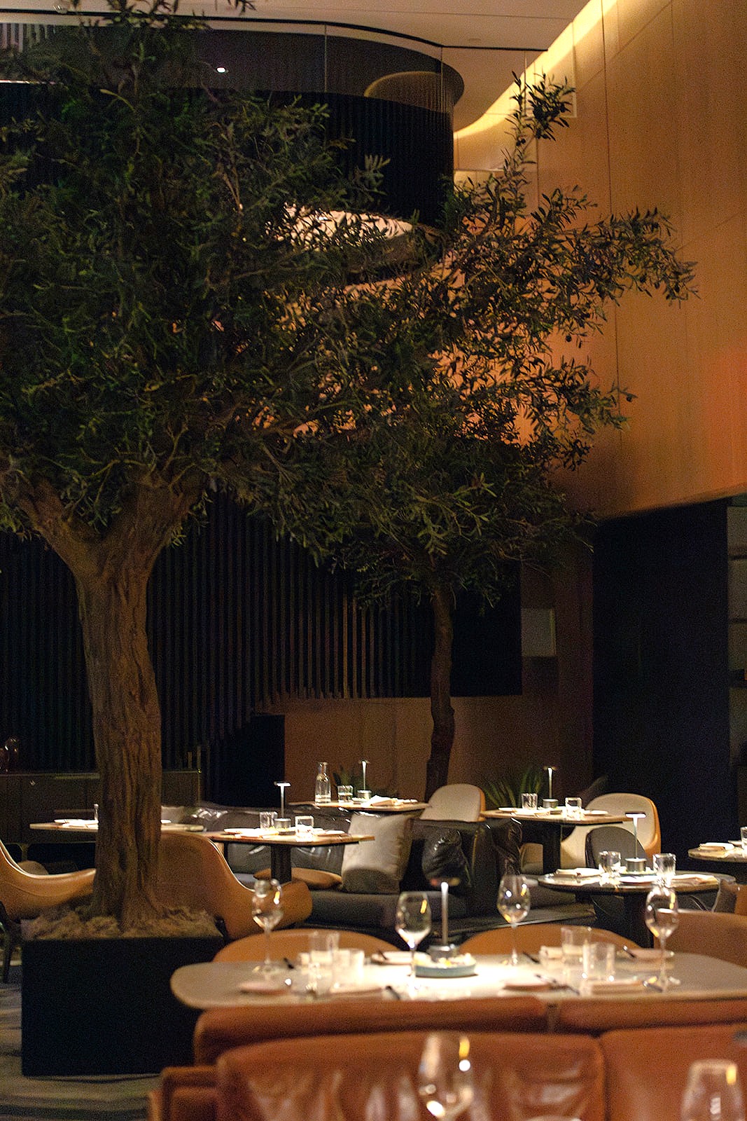 A spacious restaurant featuring neatly arranged tables and chairs in the center of the room, inviting for dining experiences