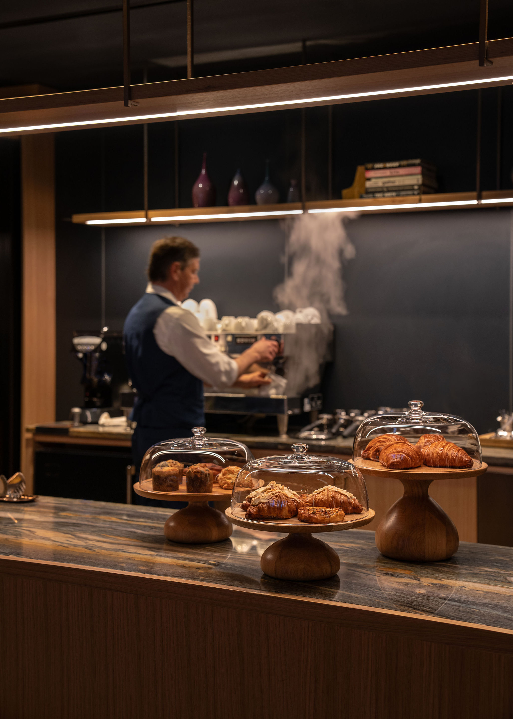A man is skillfully preparing food in a modern kitchen, surrounded by fresh ingredients and cooking utensils