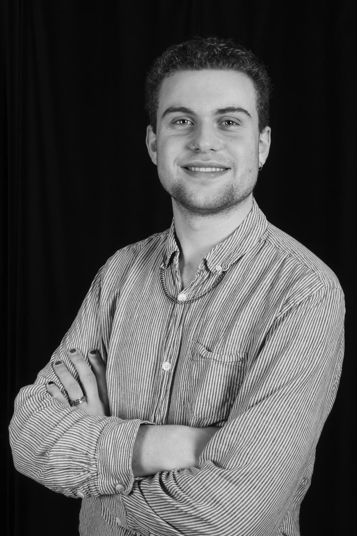 Michael Renfro in a striped shirt and smiling at the camera