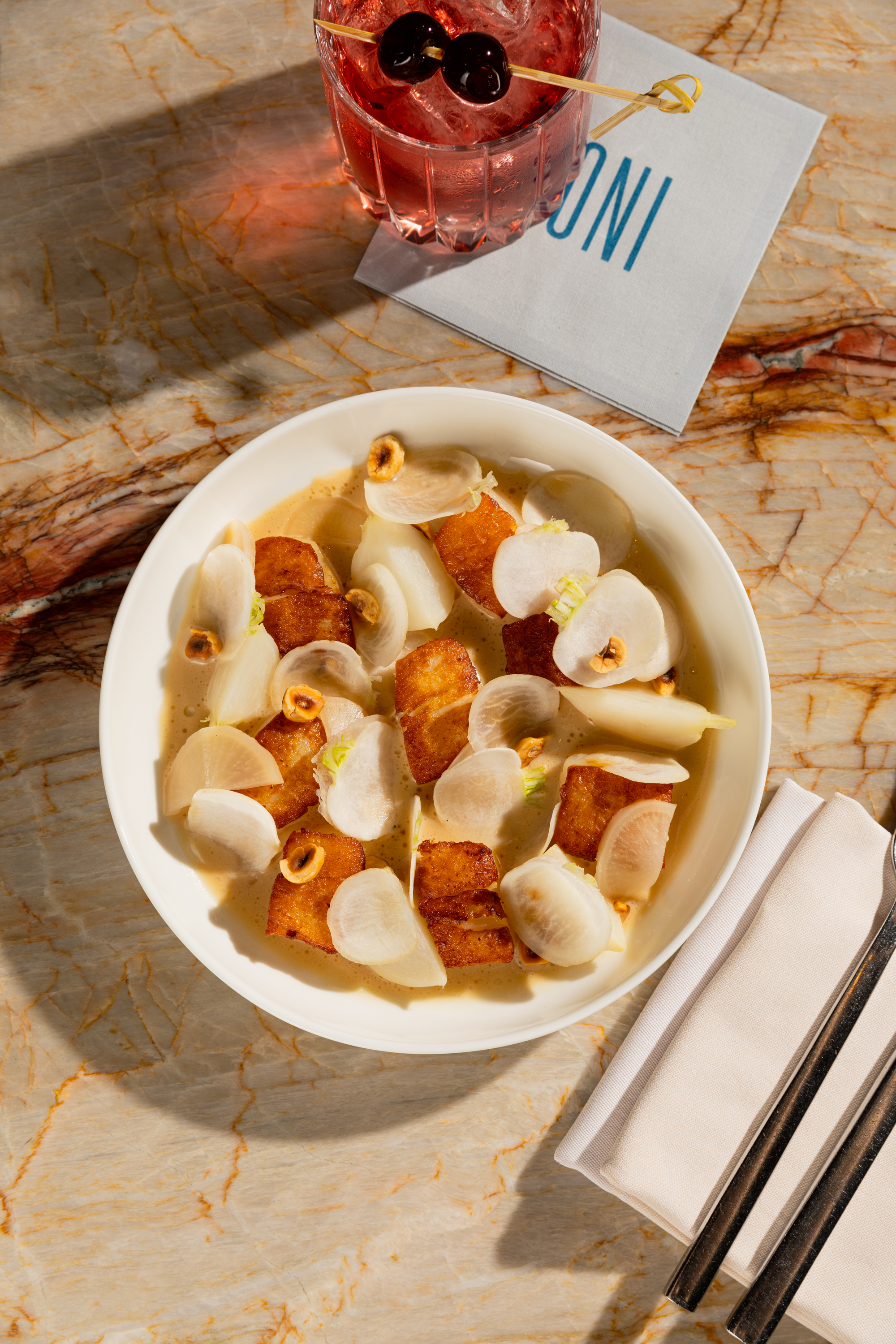 A bowl of food placed elegantly on a polished marble table, showcasing a delightful meal