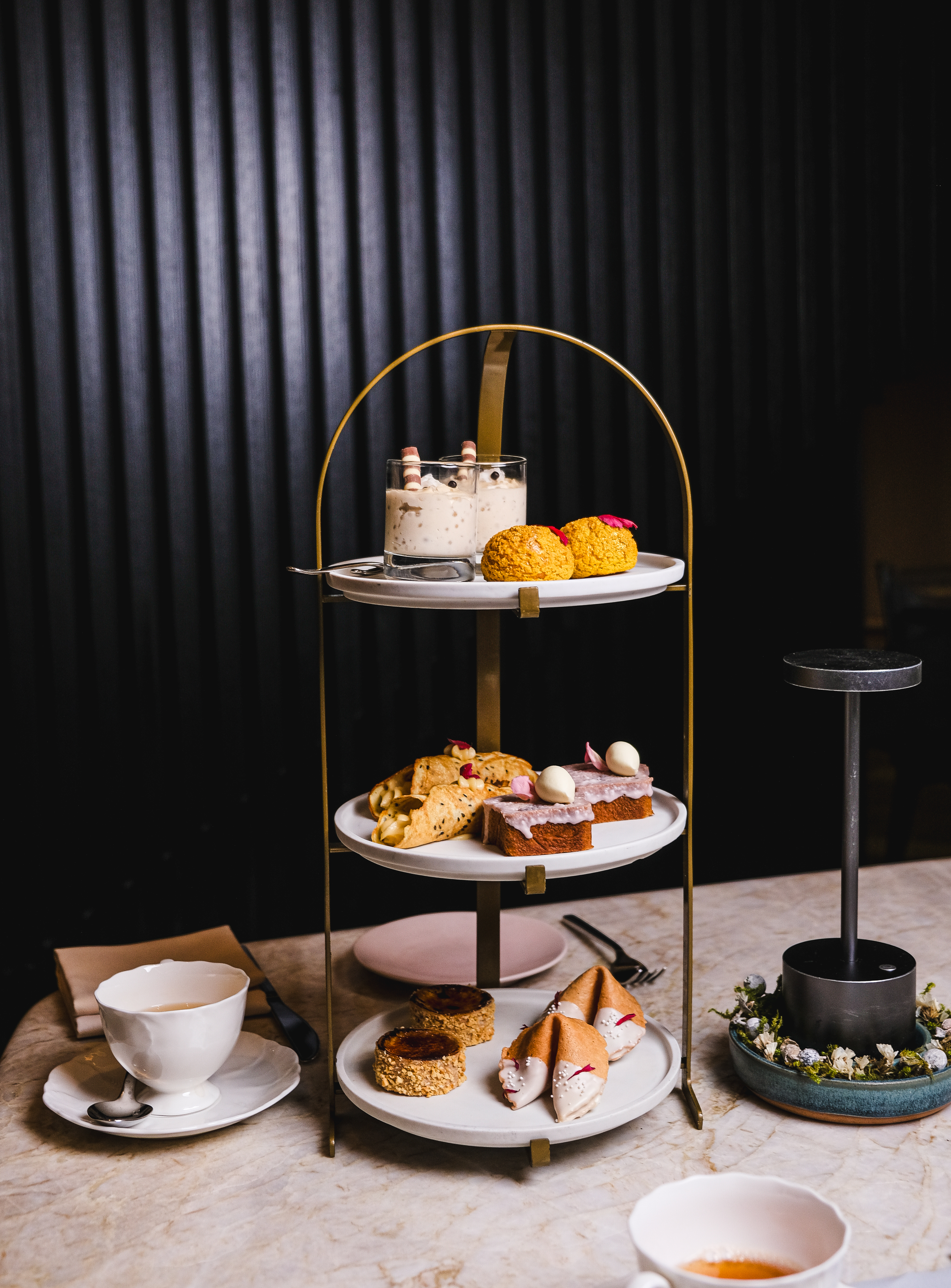 A beautifully arranged table featuring three tiered cakes 
