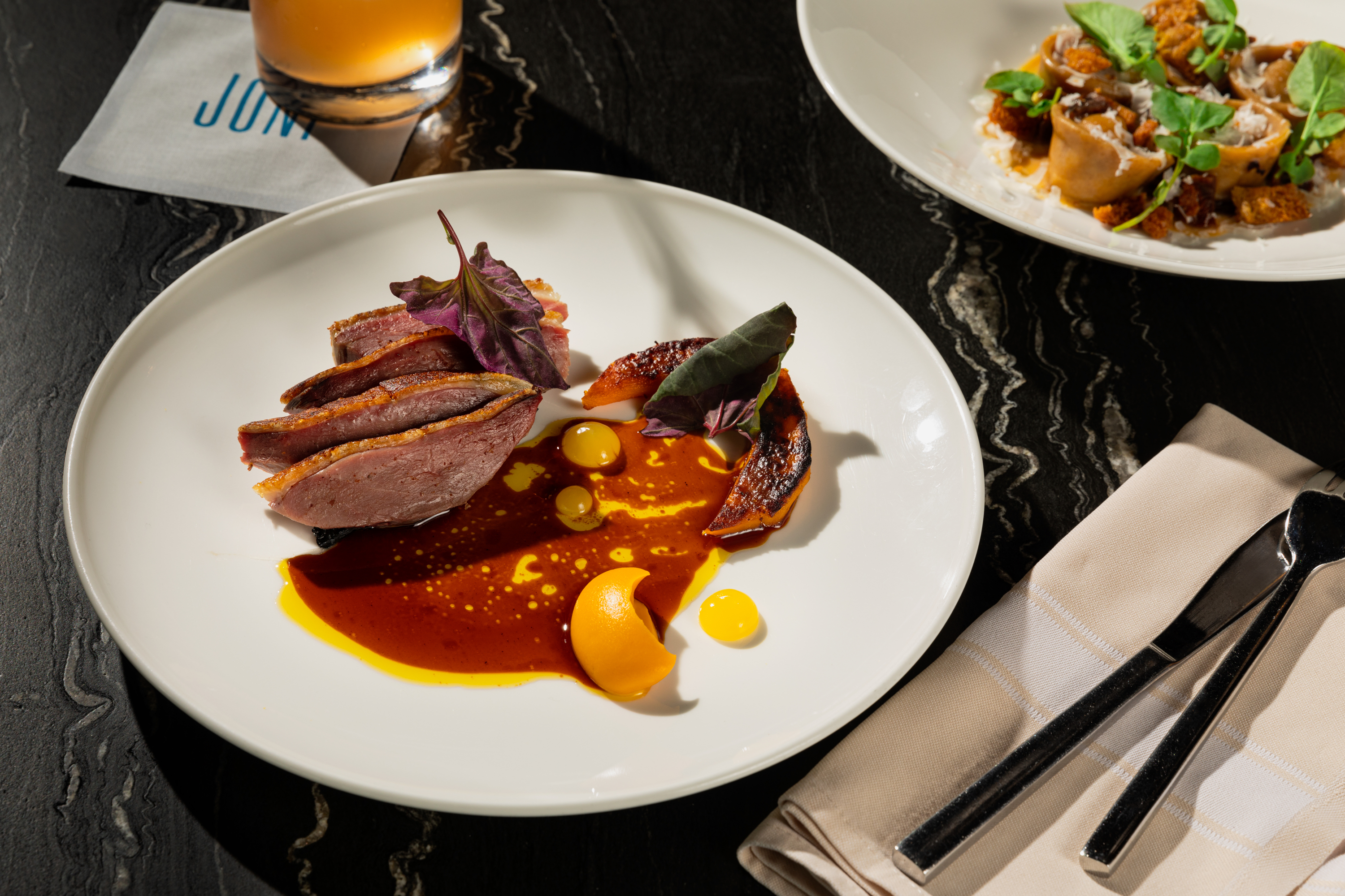 A table set with two plates of food and drinks, showcasing a delightful dining experience