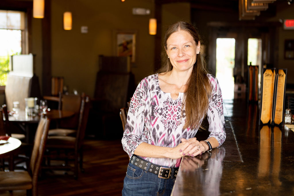 a person standing in front of a restaurant
