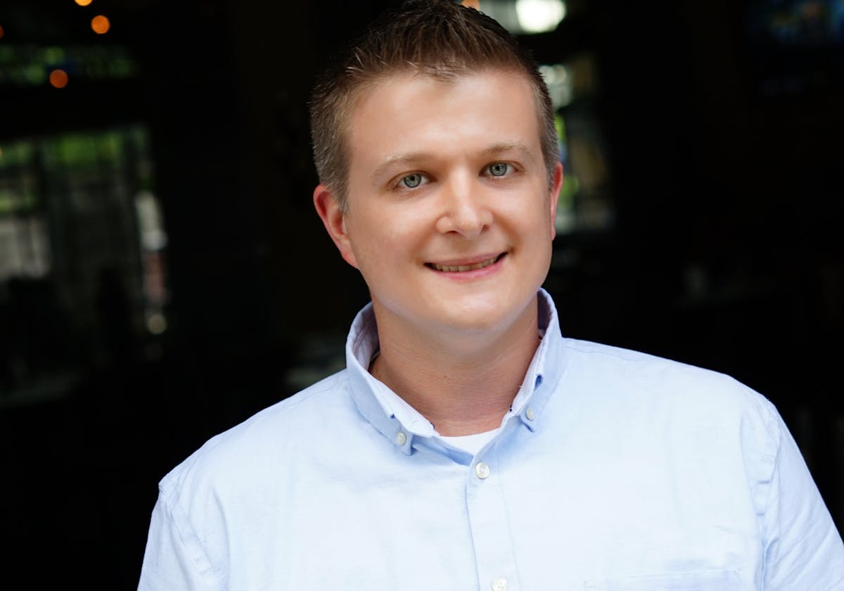 a smiling young man in a blue shirt