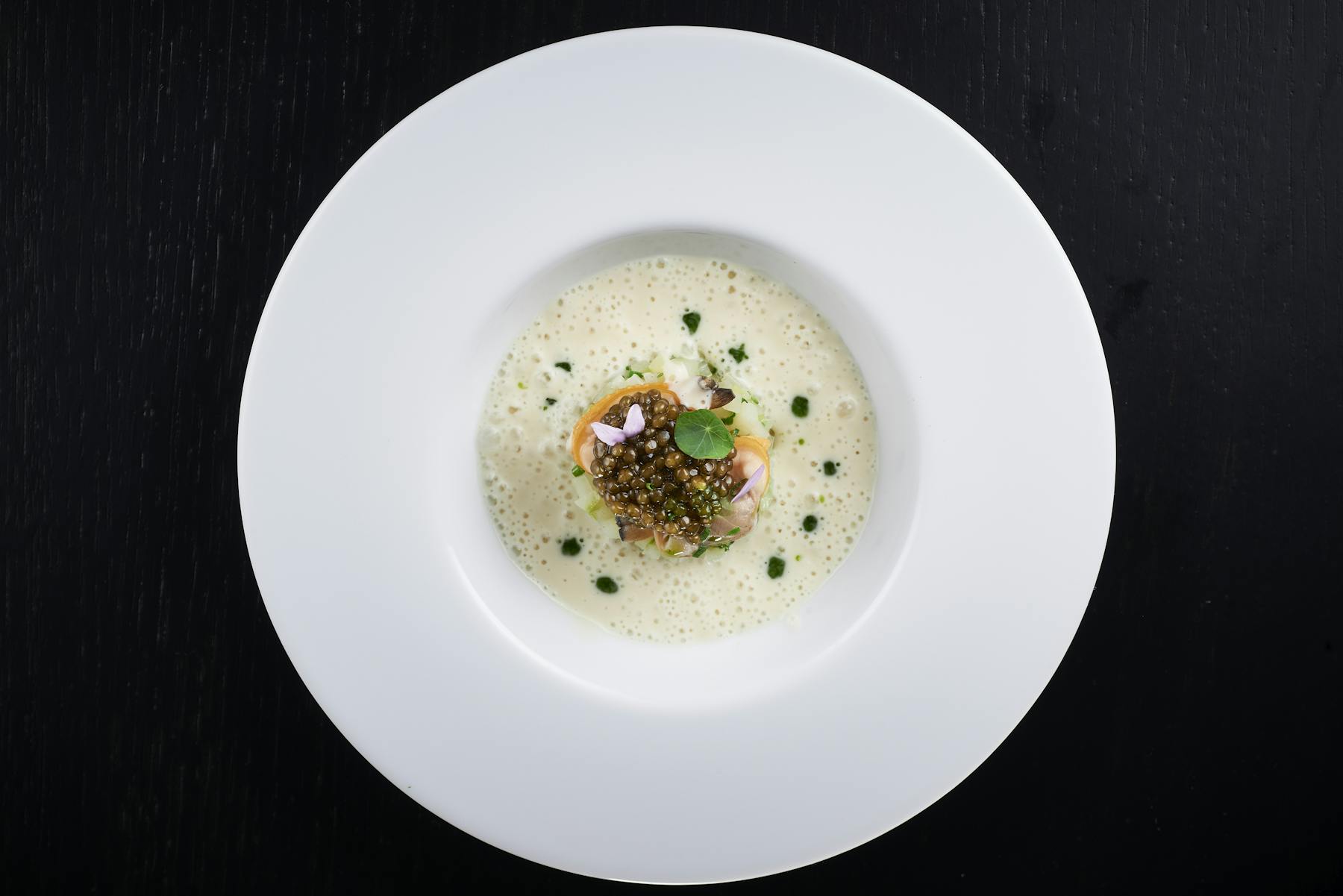 a white plate with soup