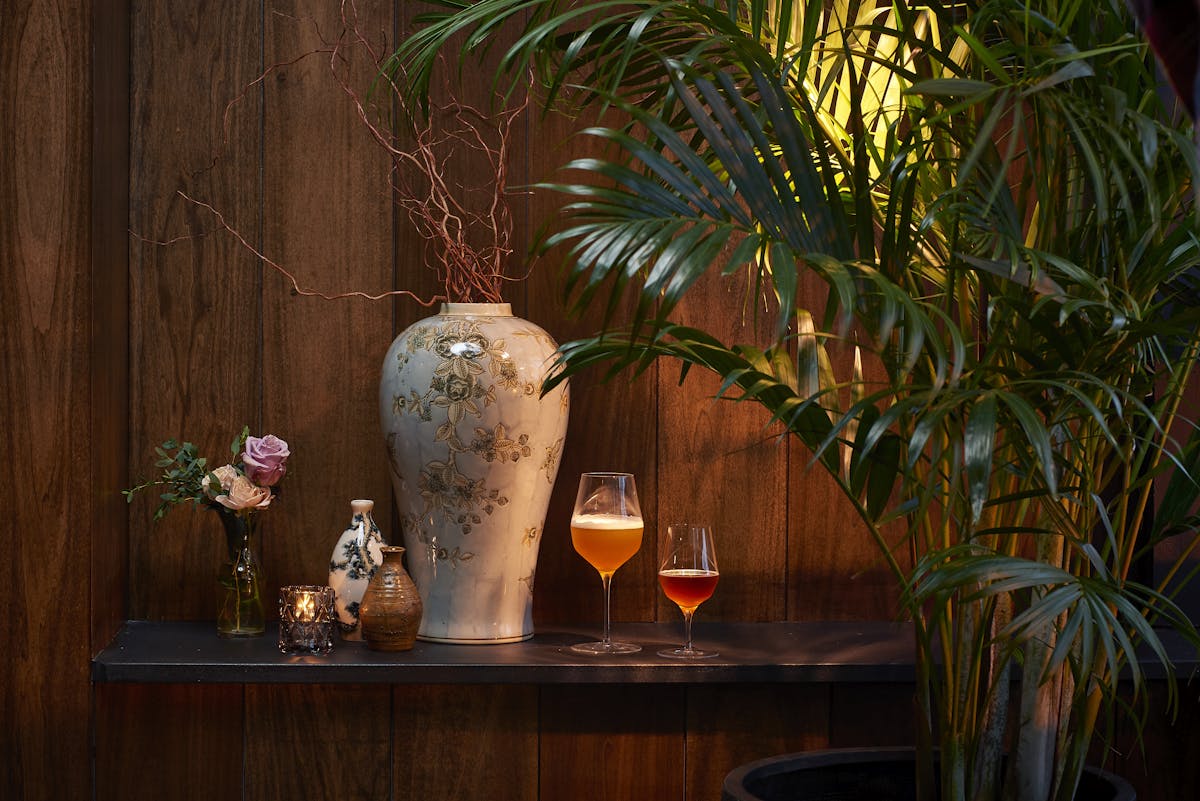 a vase filled with flowers sitting on top of a wooden table