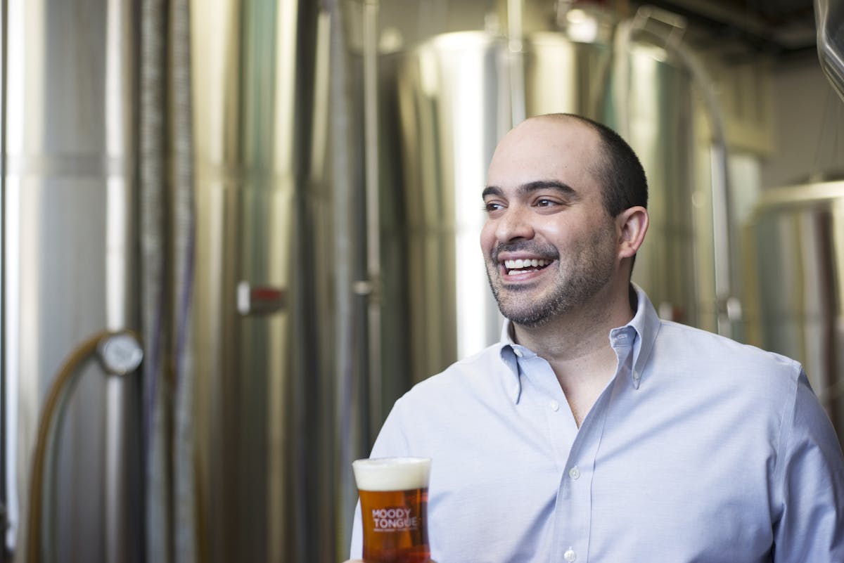 jared rouben posing with a glass of beer