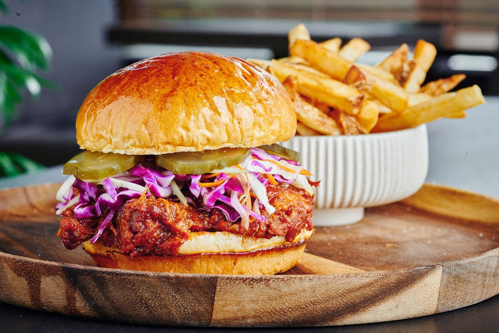 a close up of a sandwich and fries on a plate