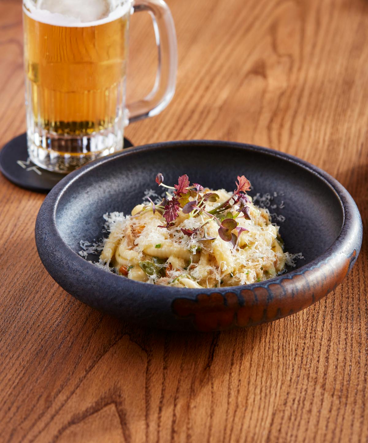 a bowl of food sitting on top of a wooden table