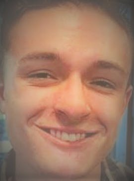 a close up of a man smiling for the camera