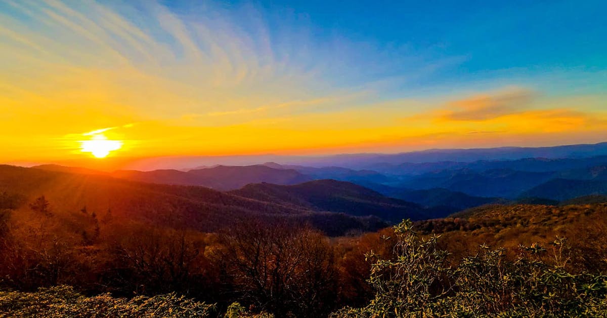 a sunset over a mountain