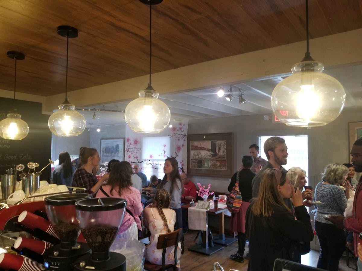 a group of people standing around a table with wine glasses