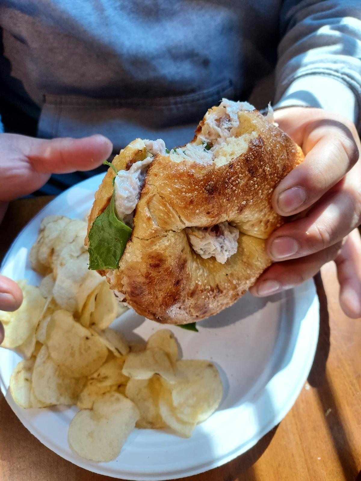 a hand holding a piece of food on a plate