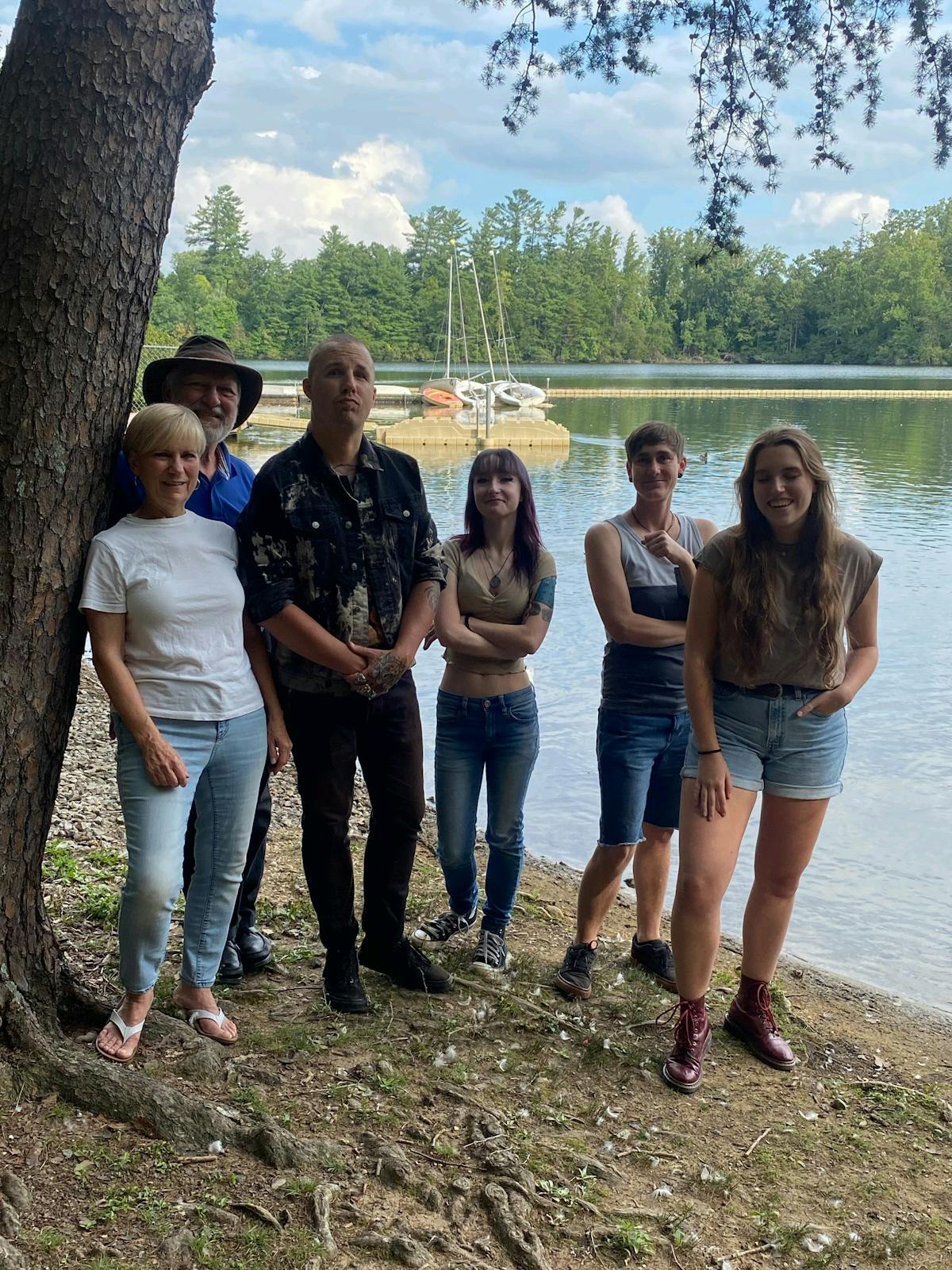 a group of people standing next to a river
