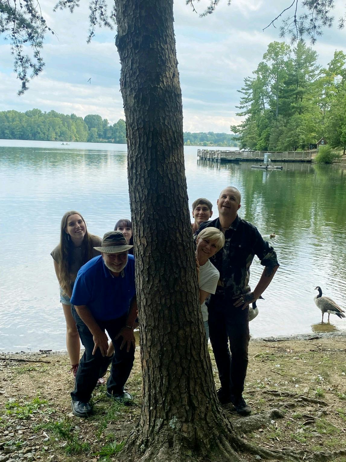 a group of people standing next to a body of water