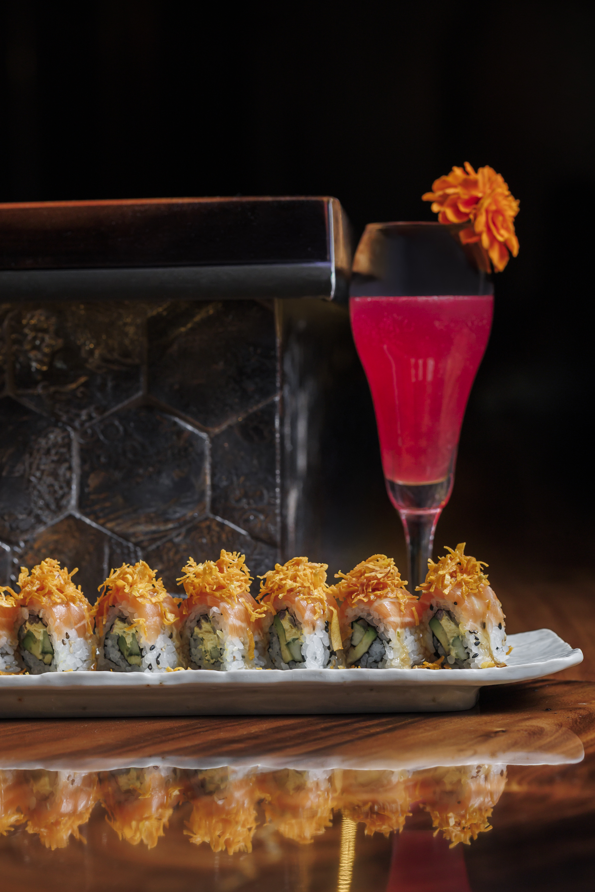 Salmon Acevichado*  sliced salmon, avocado, grilled onions, aji cream cheese, yuzu acevichado, orange kabayaki and Tender Heart: gin, prickly pear, chicha morada, lemon bubbles