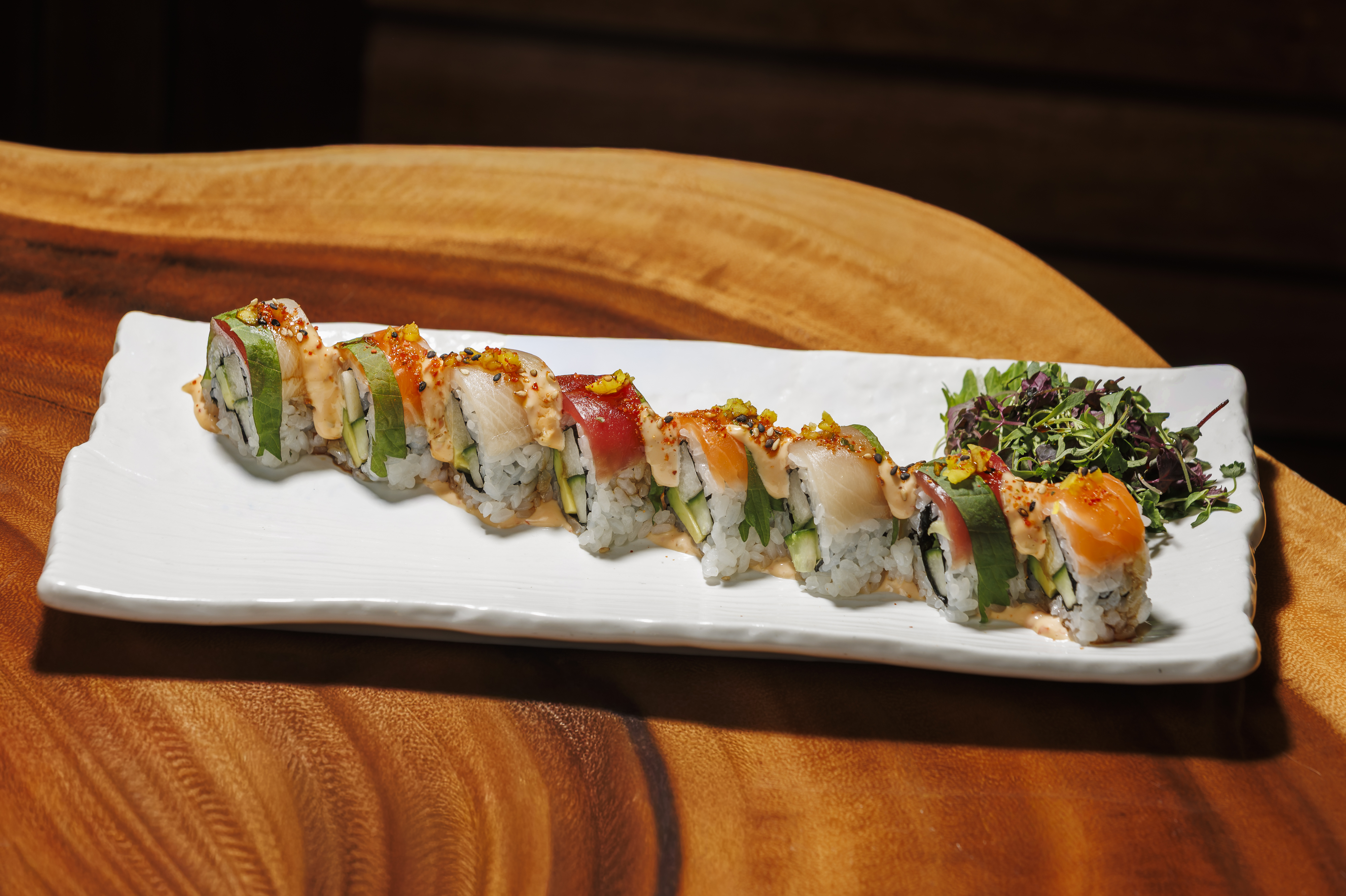 a plate of sushi on a wood table