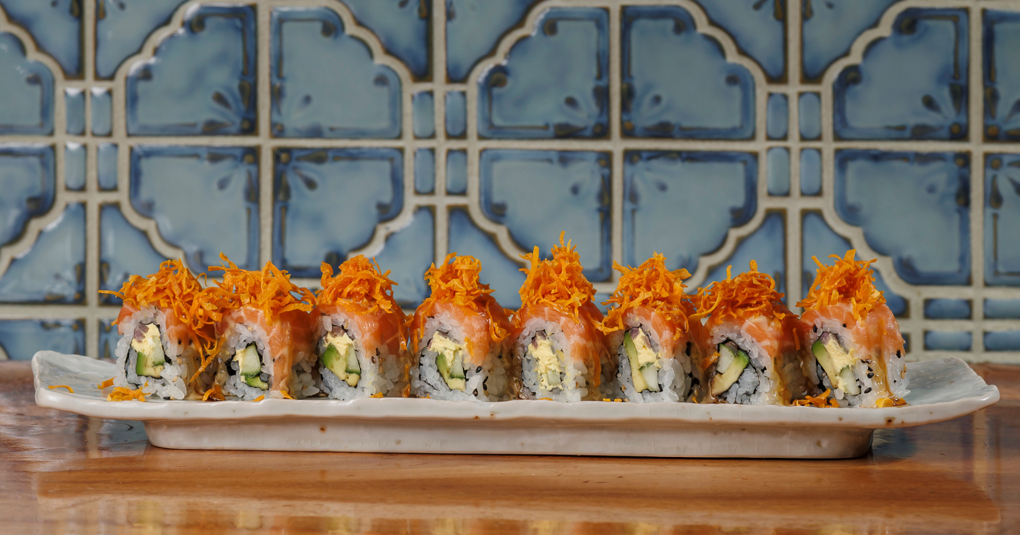 Salmon Acevichado: sliced salmon. avocado. grilled onions. aji cream cheese. yuzu acevichado. orange kabayaki