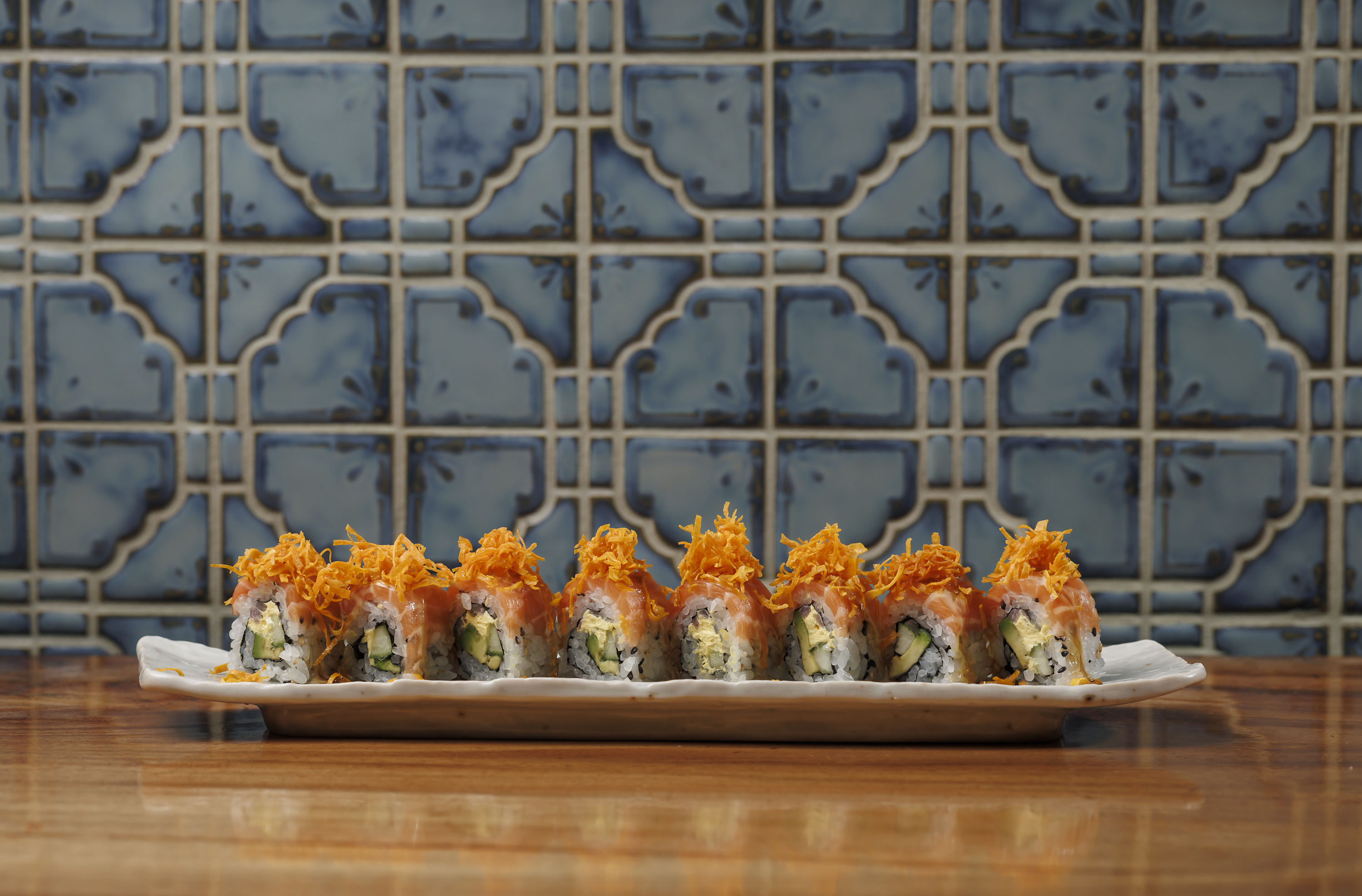 Salmon Acevichado: sliced salmon. avocado. grilled onions. aji cream cheese. yuzu acevichado. orange kabayaki