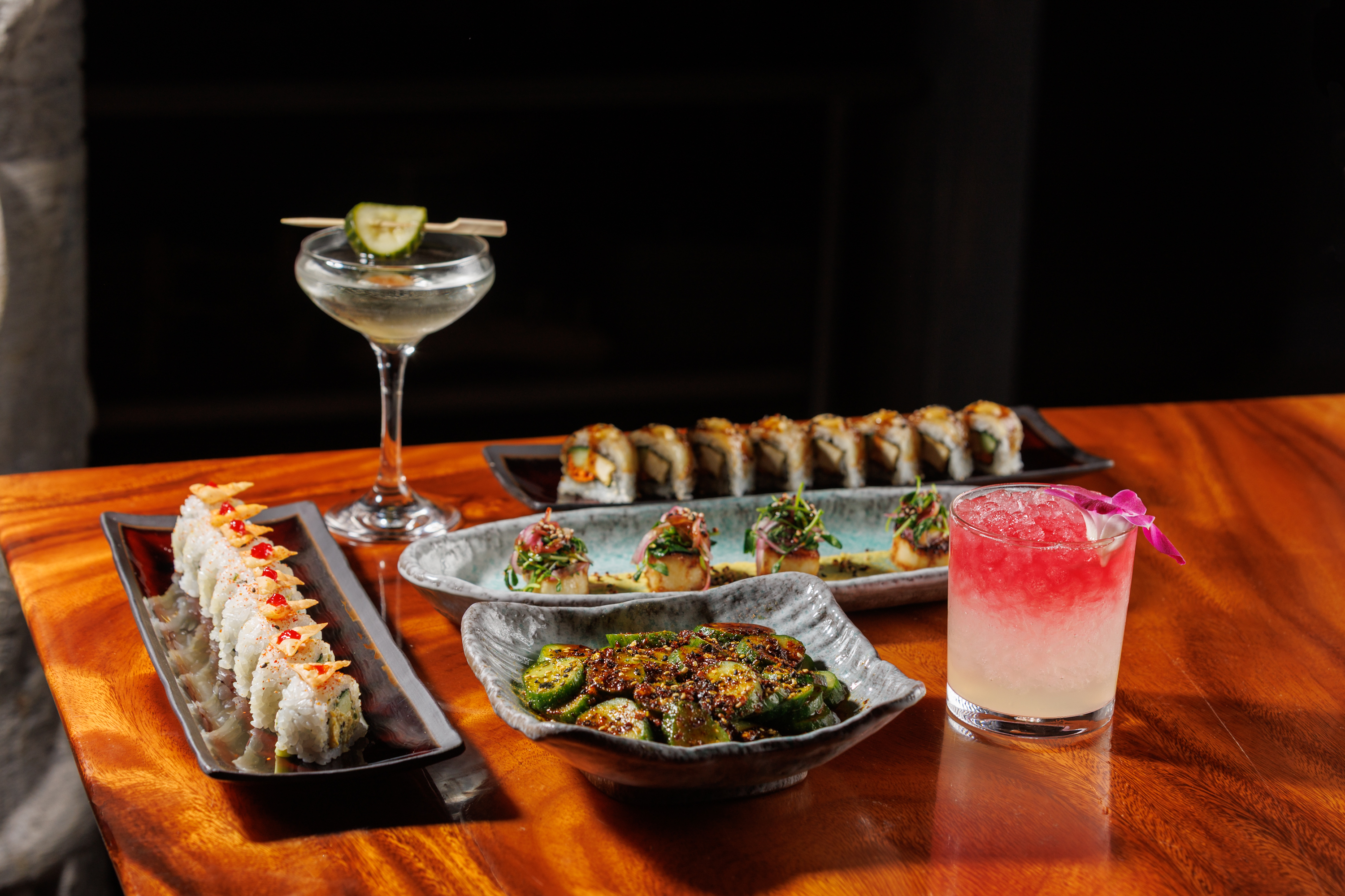 a table with plates of sushi and drinks