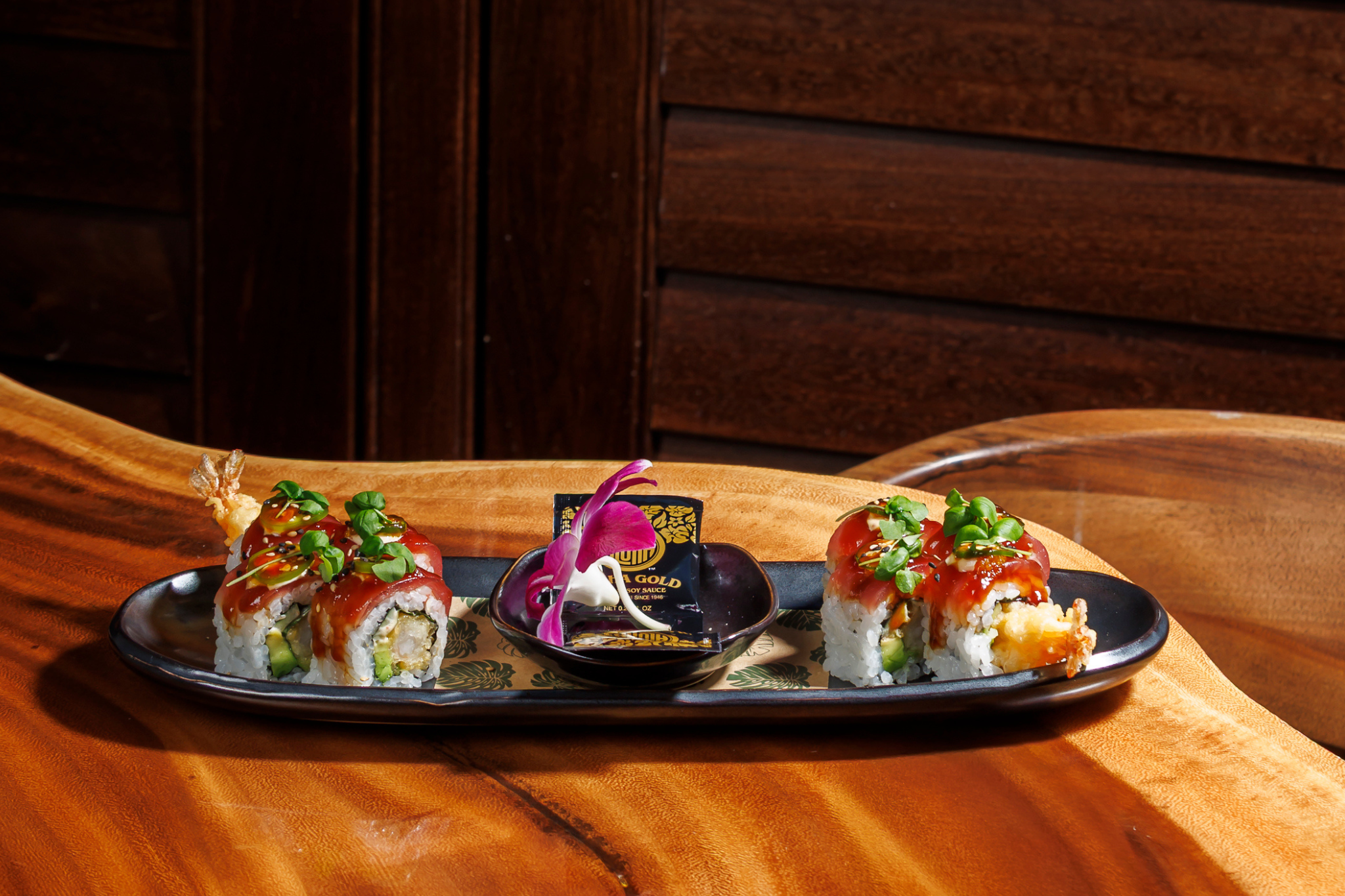 a plate of sushi on a wood surface
