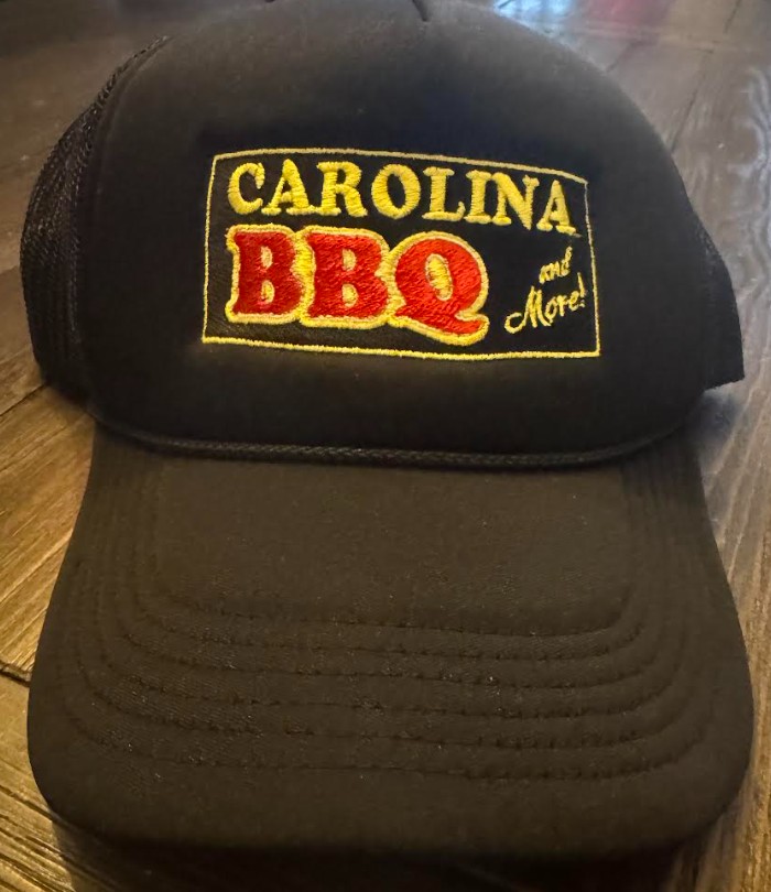 a black hat with a yellow and red logo