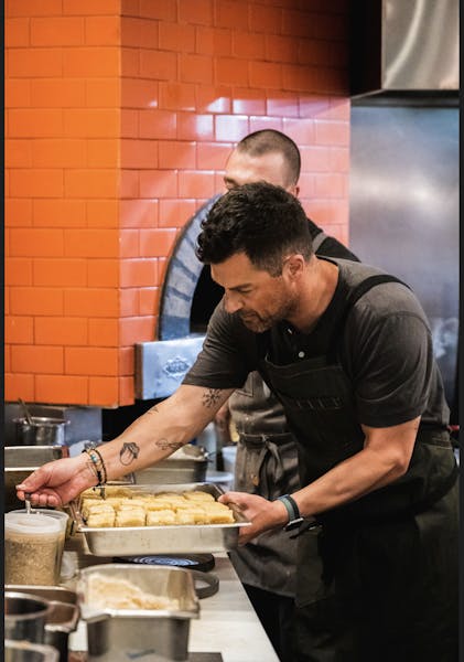 a man cooking in a kitchen preparing food