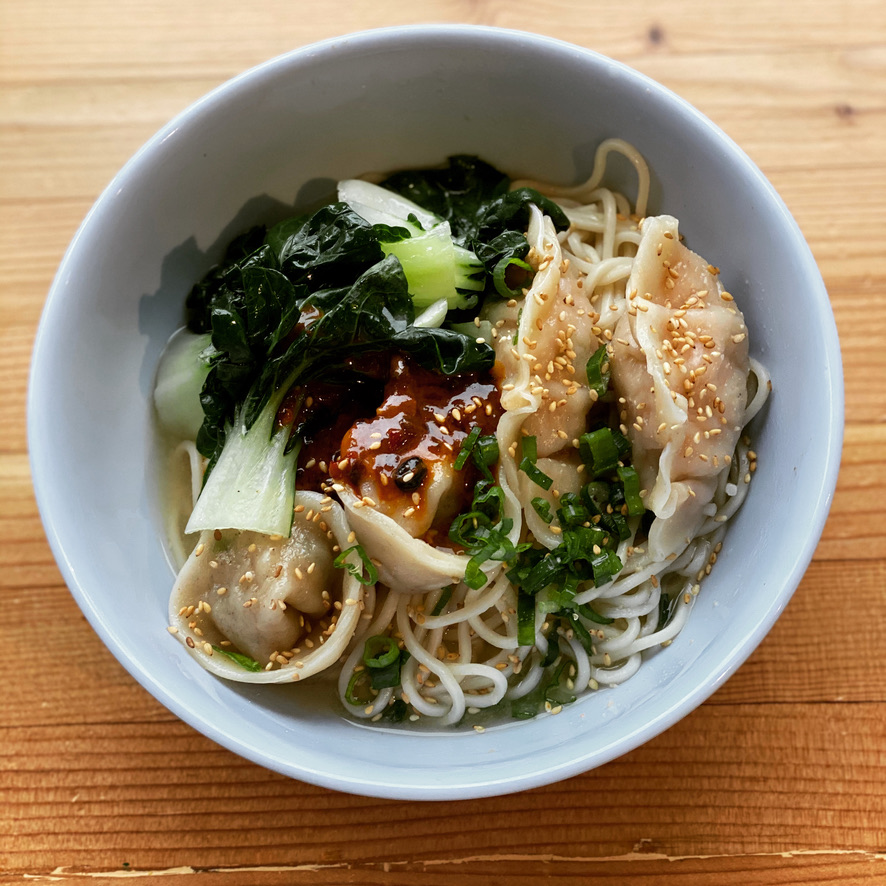 a bowl of food on a wooden table