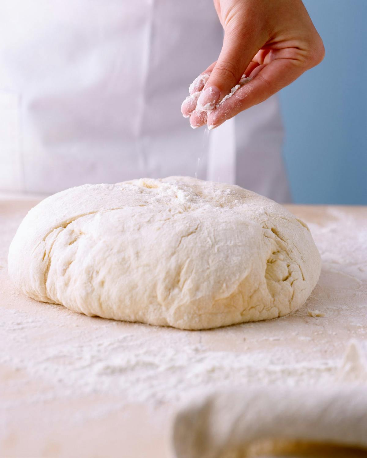 a close up of a person holding a piece of bread