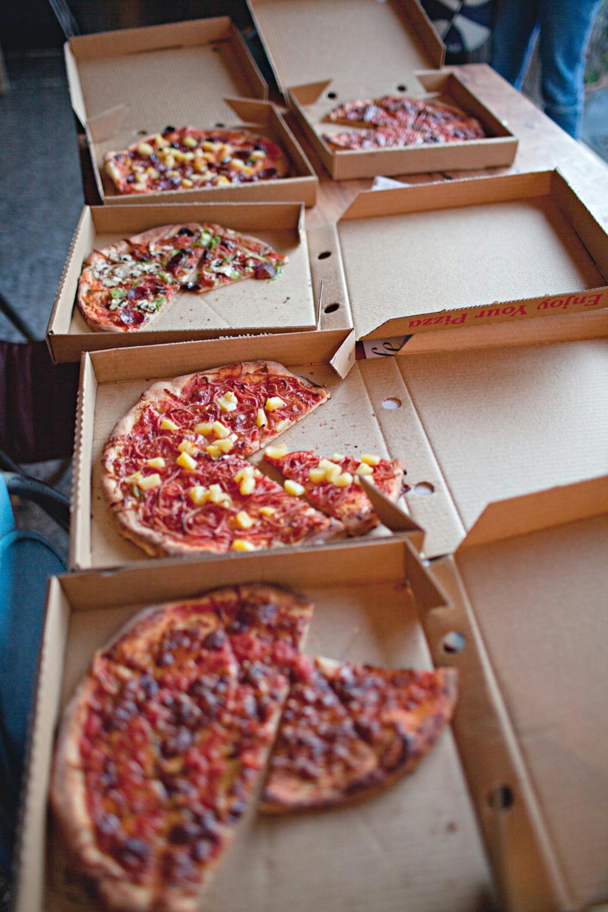 a pizza sitting on top of a wooden table