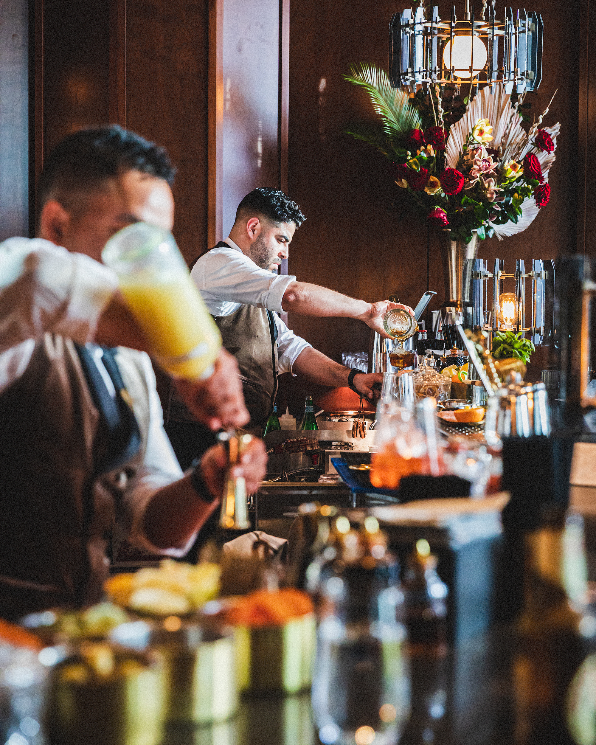 a man sitting at a table with wine glasses