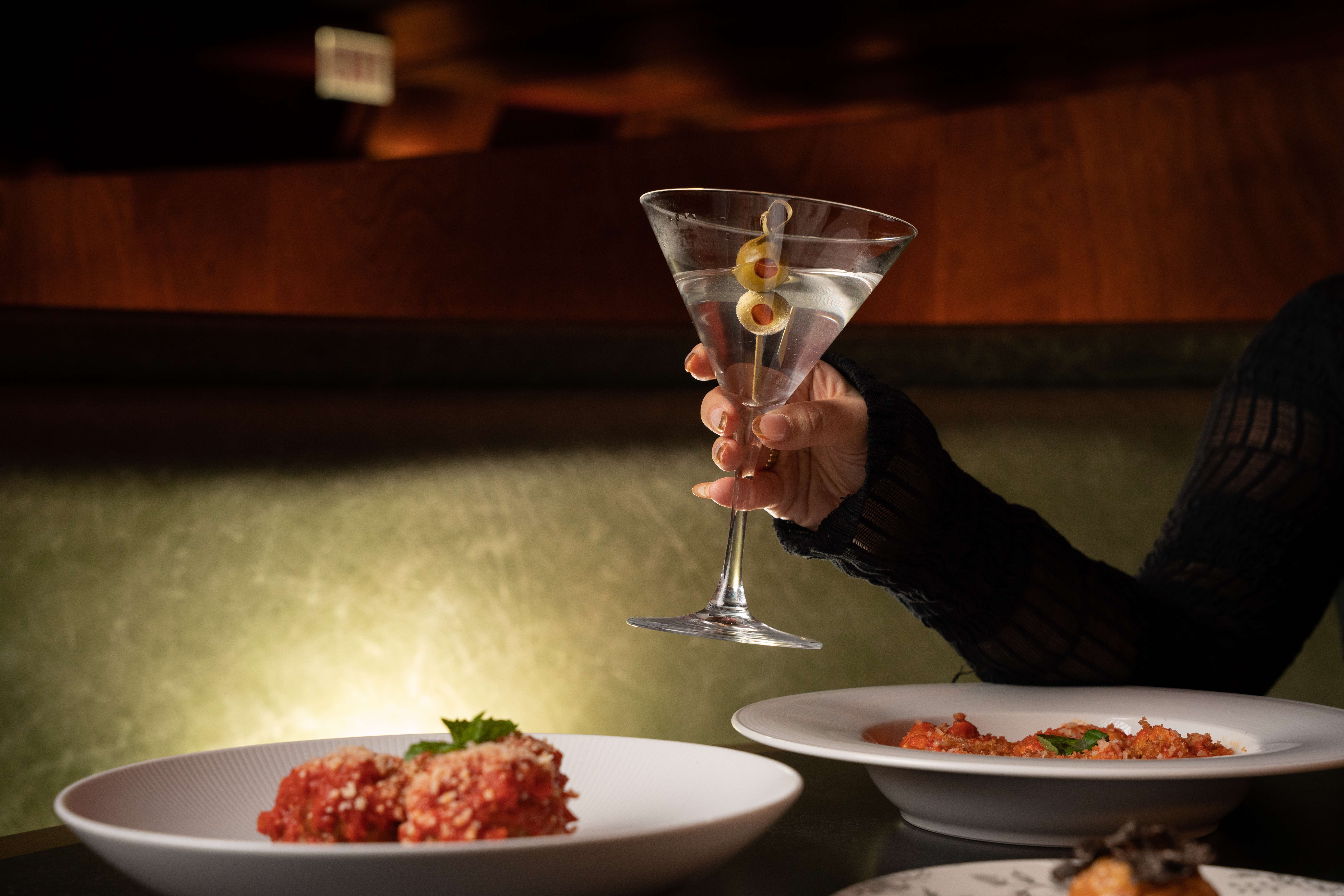 a person sitting at a table with a plate of food