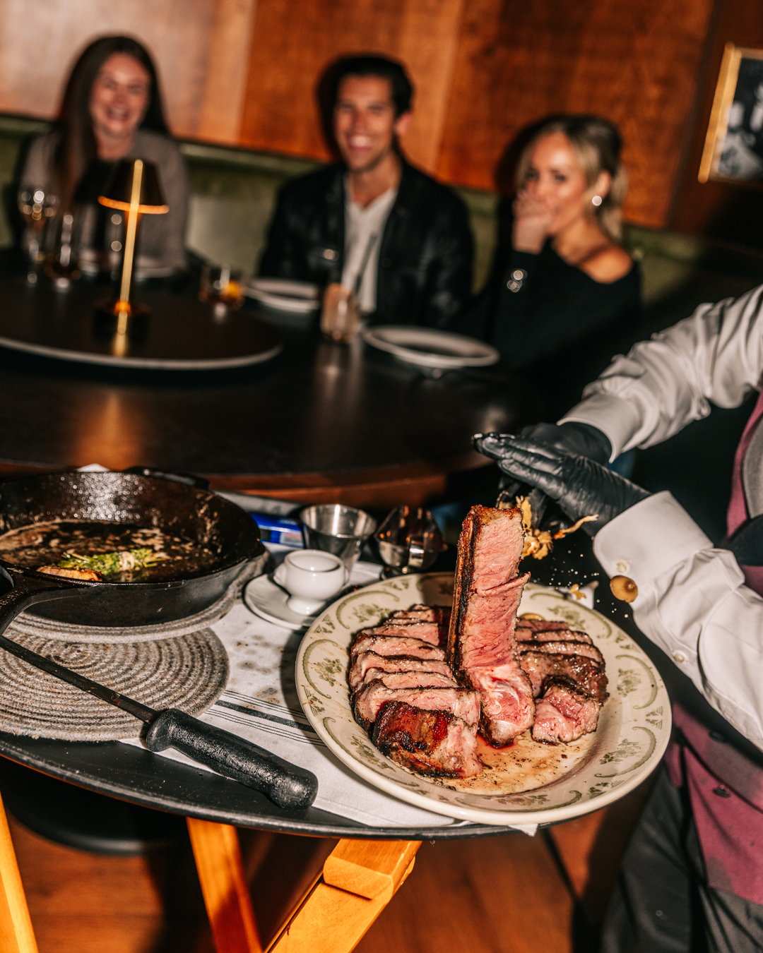a group of people sitting at a table with a plate of food