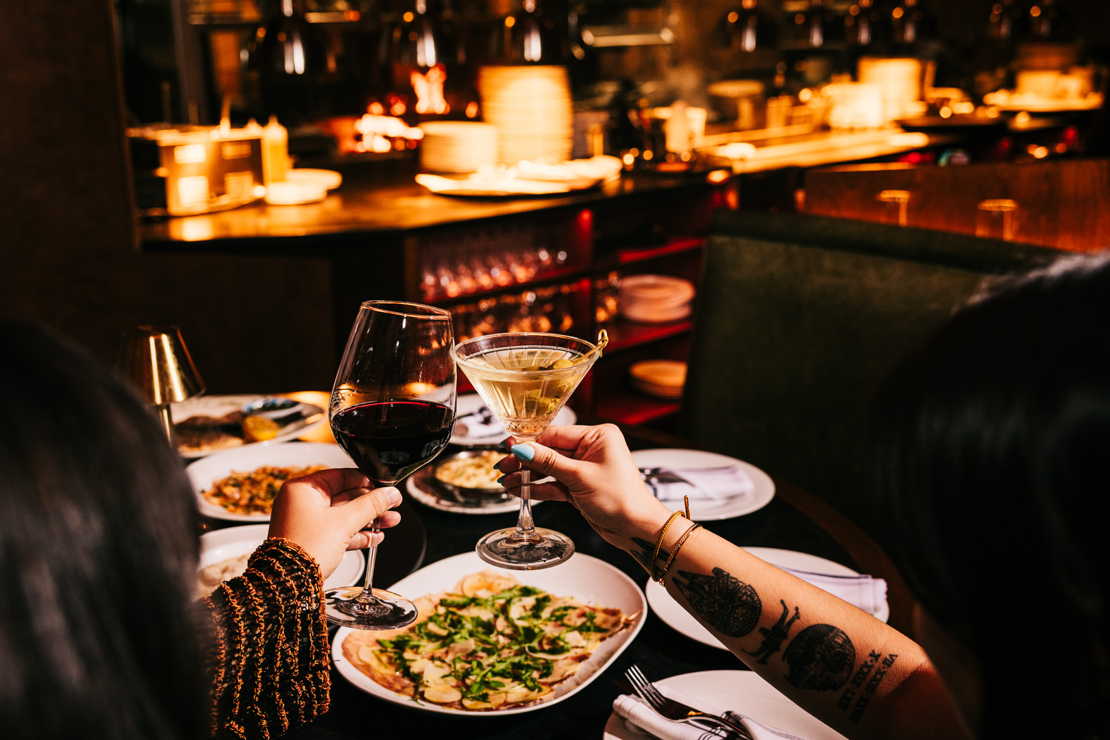 a person sitting at a table with a plate of food