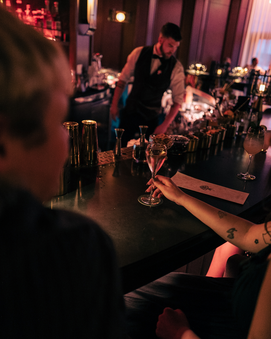 a group of people sitting at a table with wine glasses