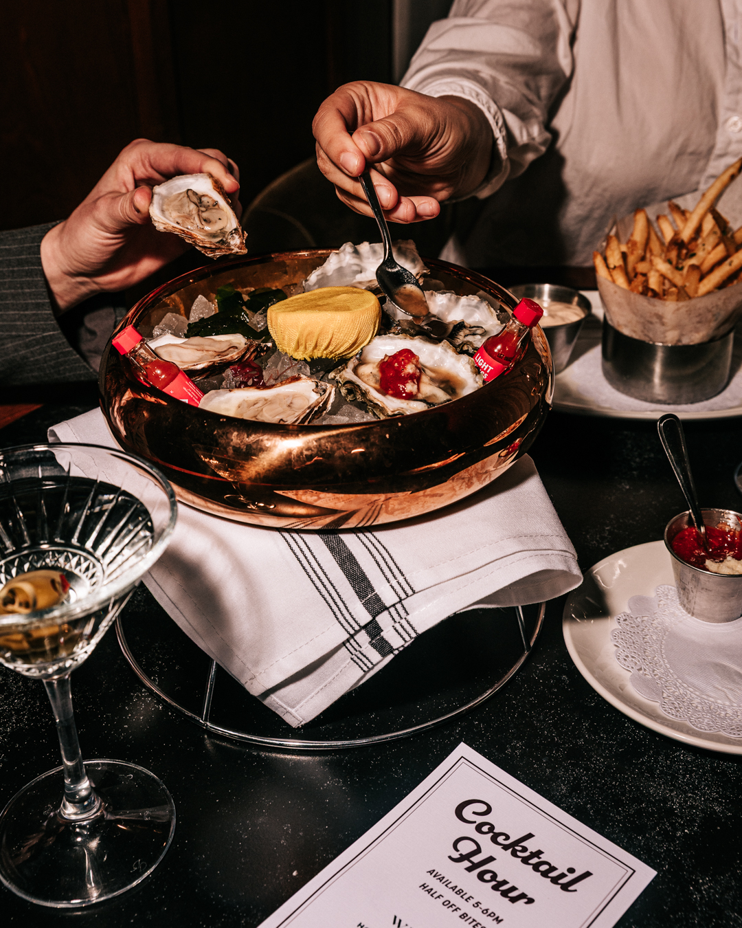 a person sitting at a table with a cake on a plate