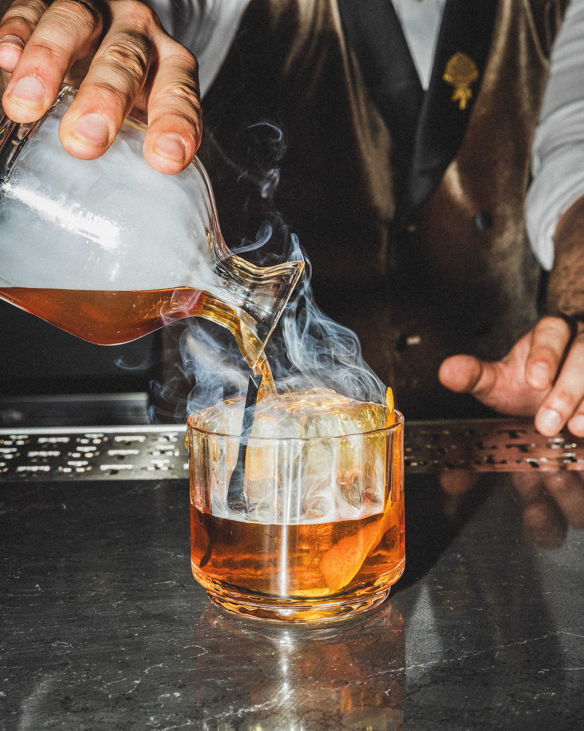 a man holding a glass of water on a table