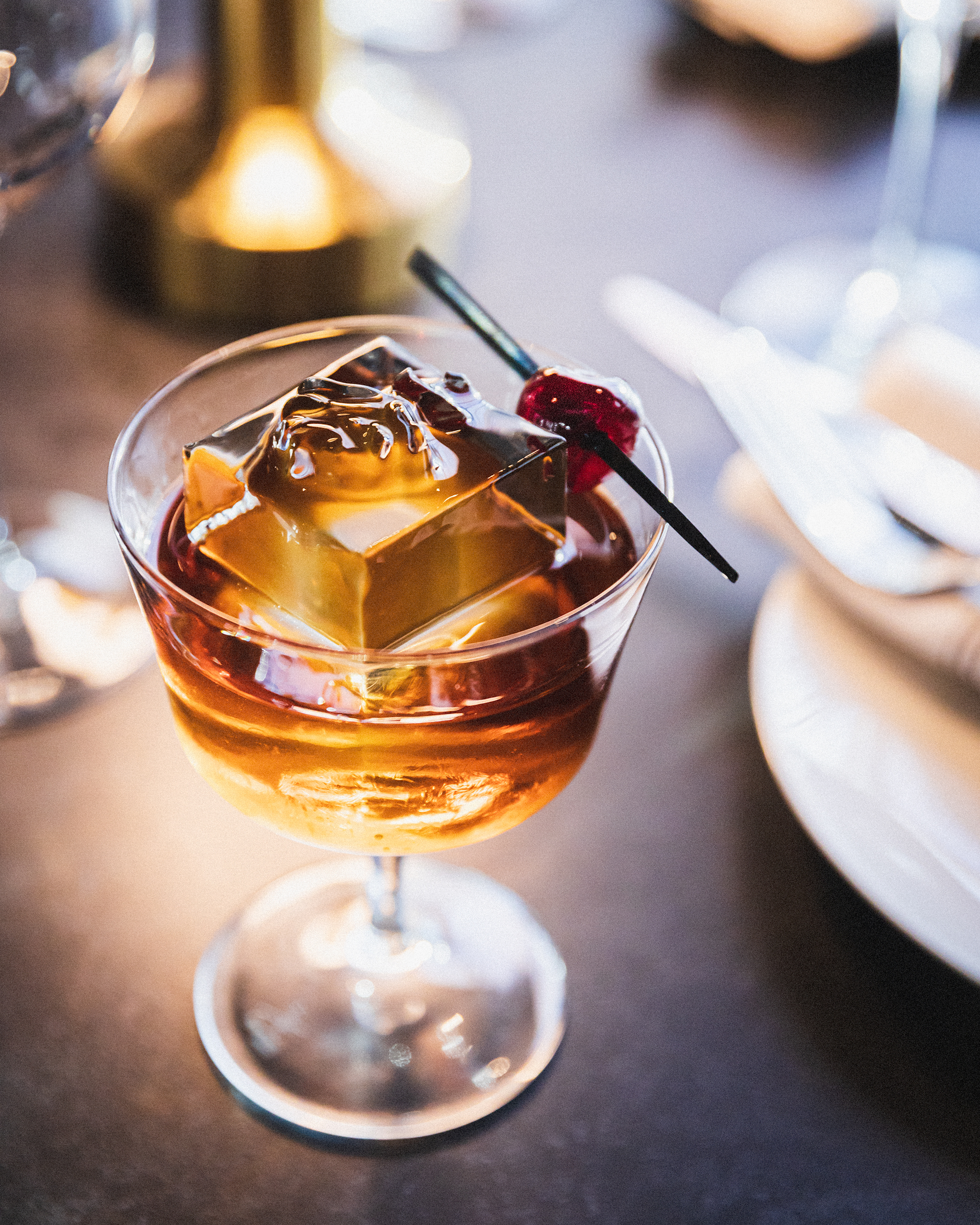 a glass with a drink and a straw