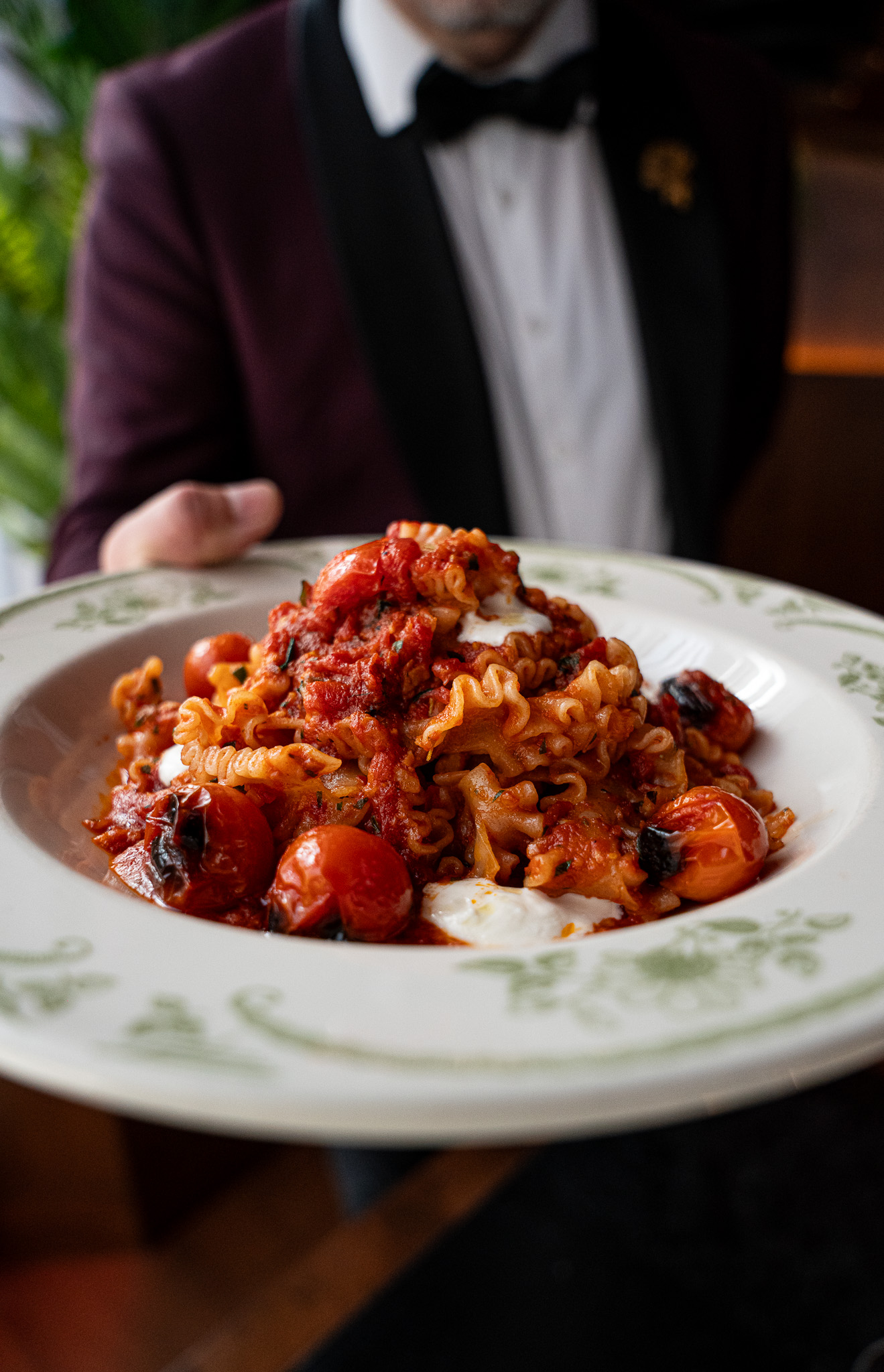 a plate of pasta with tomatoes and sauce