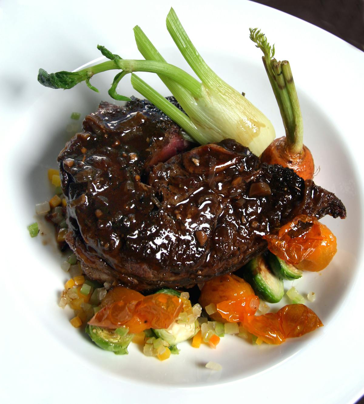 a white plate topped with meat and vegetables