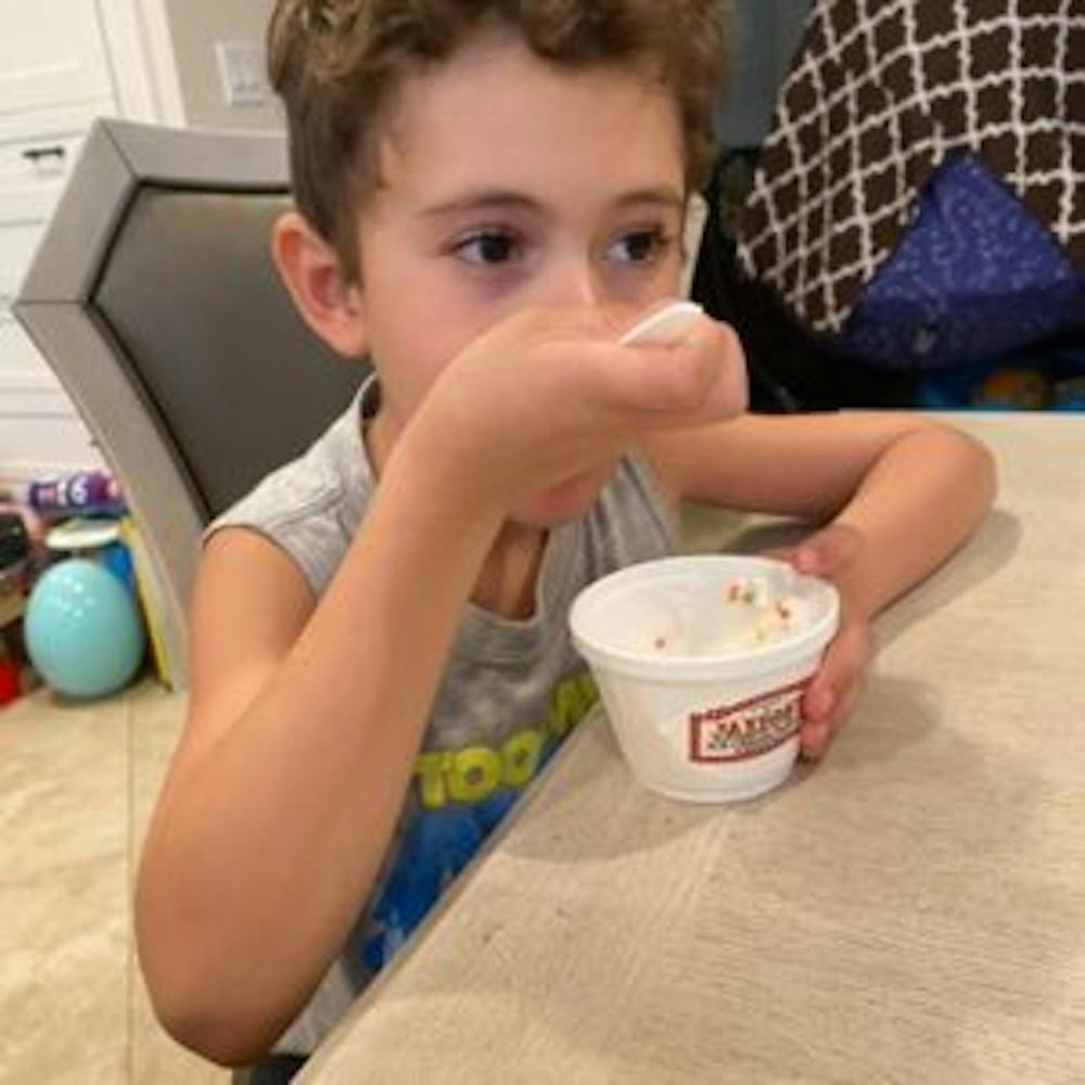 a boy eating a sundae