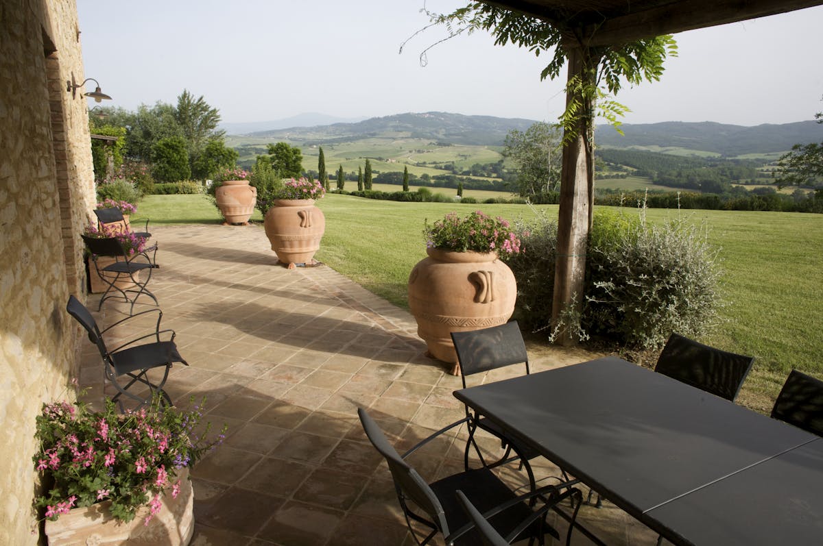 a vase of flowers sitting on a bench